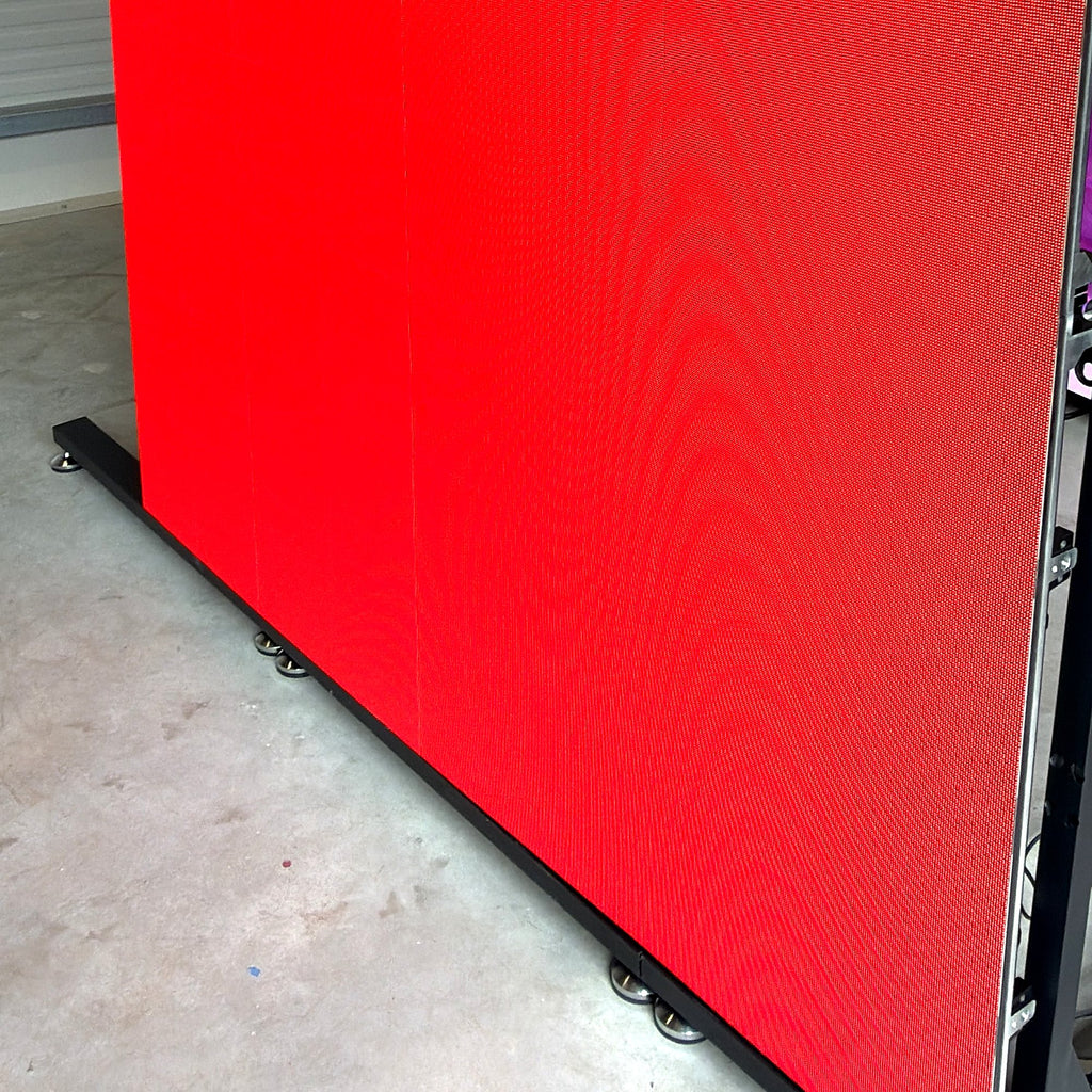 LED wall in full red display, close-up of panel edges