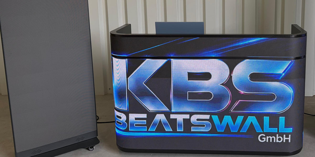 Lit LED DJ desk with the KBS BeatsWall logo on its LED front